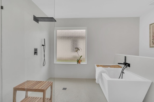 full bathroom with a freestanding bath and a tile shower