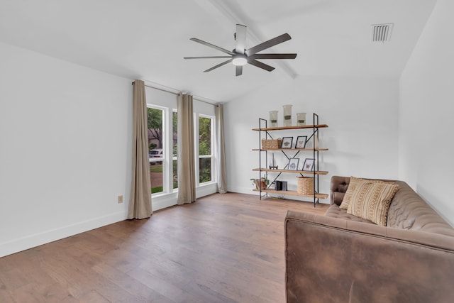 living room with lofted ceiling with beams, a ceiling fan, baseboards, wood finished floors, and visible vents