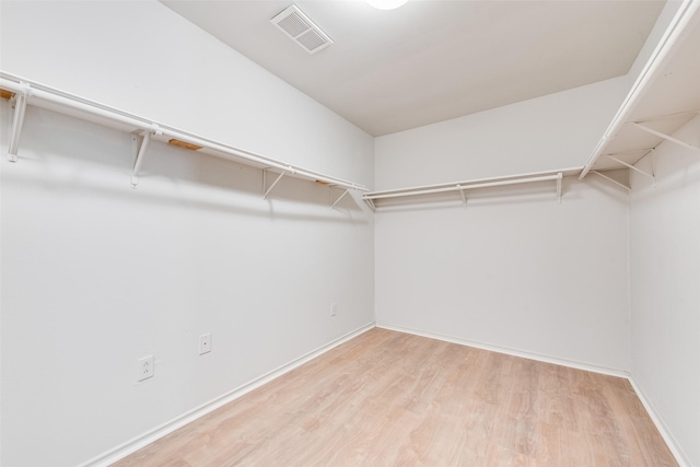 walk in closet with visible vents and wood finished floors