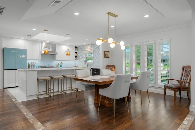 dining room with visible vents, recessed lighting, crown molding, and wood finished floors