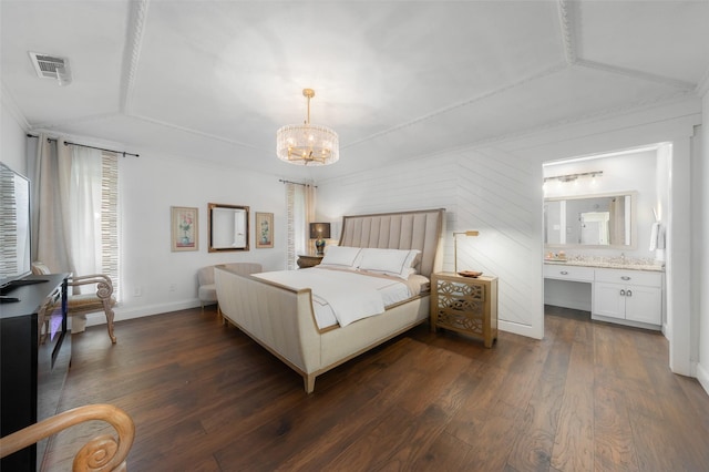 bedroom featuring connected bathroom, dark wood-style flooring, a chandelier, and visible vents