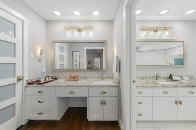 full bathroom with vanity and wood finished floors