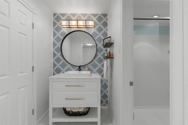 bathroom with vanity and a shower
