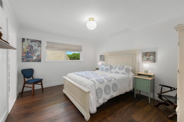 bedroom with baseboards, ornamental molding, dark wood-style floors, and visible vents