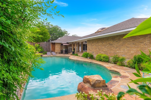 view of pool with a fenced in pool, fence, and a patio