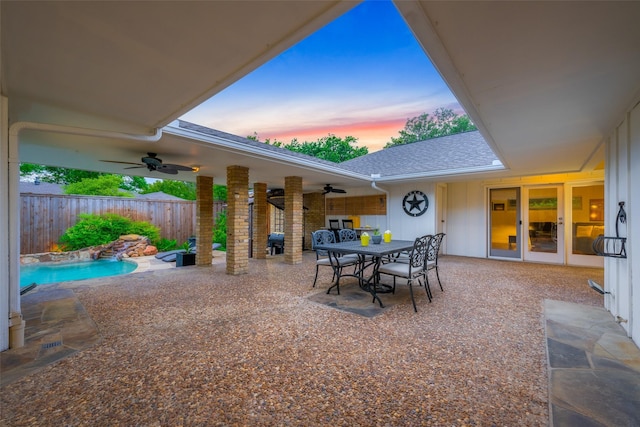 view of patio with ceiling fan, fence, outdoor dining space, and a fenced in pool