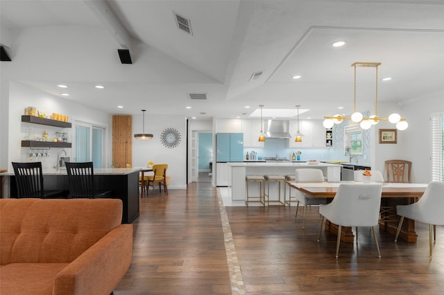 living area featuring recessed lighting, dark wood finished floors, vaulted ceiling with beams, and visible vents