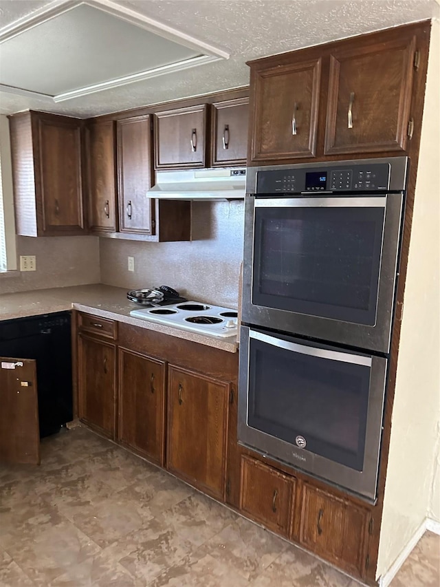 kitchen featuring dark brown cabinets, light countertops, double oven, under cabinet range hood, and black dishwasher
