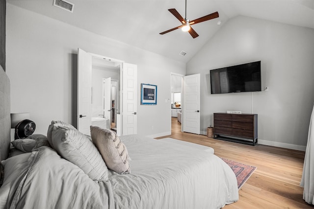 bedroom with visible vents, light wood finished floors, baseboards, and high vaulted ceiling