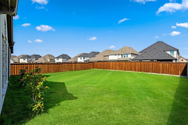 view of yard with a residential view and a fenced backyard