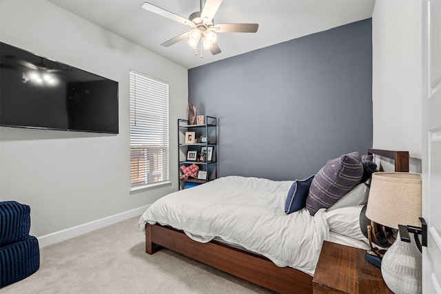 carpeted bedroom with baseboards and ceiling fan
