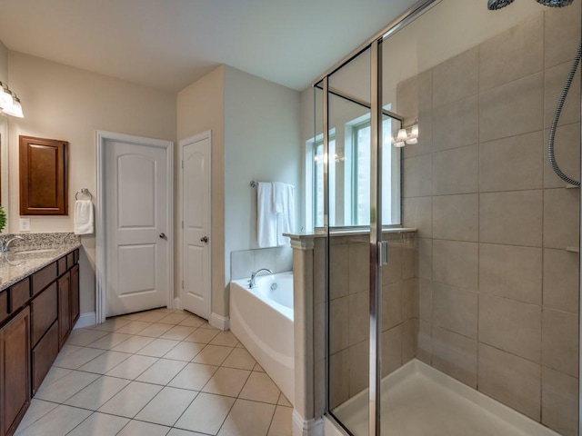 bathroom featuring vanity, tile patterned flooring, baseboards, a bath, and a shower stall