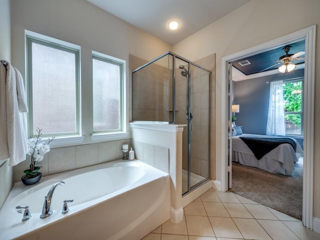 full bathroom featuring baseboards, a bath, tile patterned floors, a shower stall, and ensuite bath