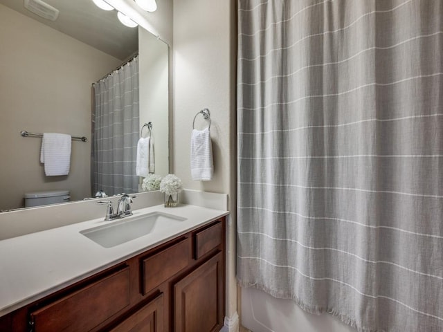 full bathroom with visible vents, toilet, and vanity