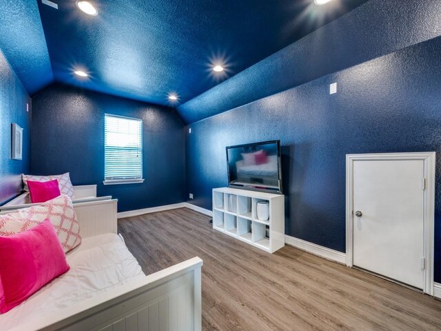 bedroom featuring recessed lighting, lofted ceiling, and wood finished floors