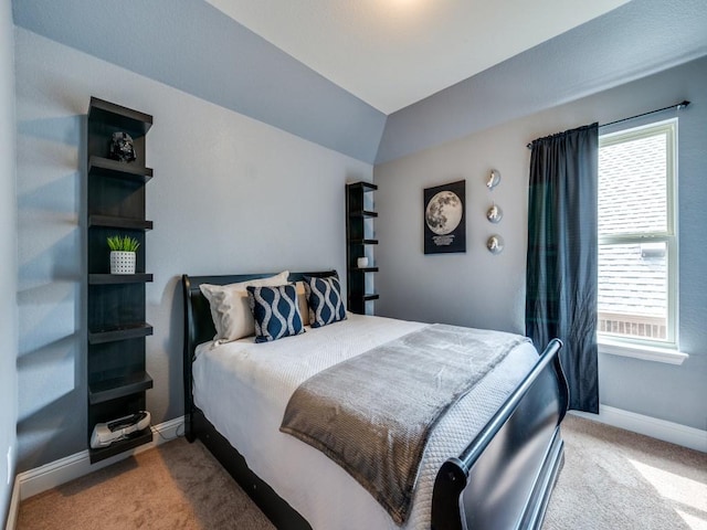 bedroom with baseboards, carpet, vaulted ceiling, and multiple windows