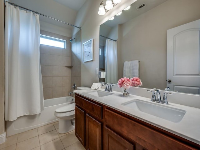 full bath featuring toilet, tile patterned floors, visible vents, and a sink