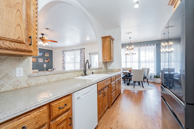 543 Islet Dr, Runaway Bay, TX 76426 - kitchen featuring dishwasher, light wood-type flooring, tasteful backsplash, a chandelier, and ceiling fan