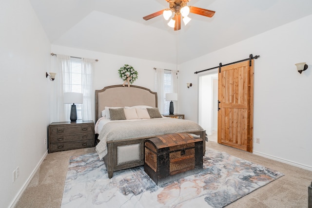bedroom with baseboards, a barn door, carpet, and multiple windows