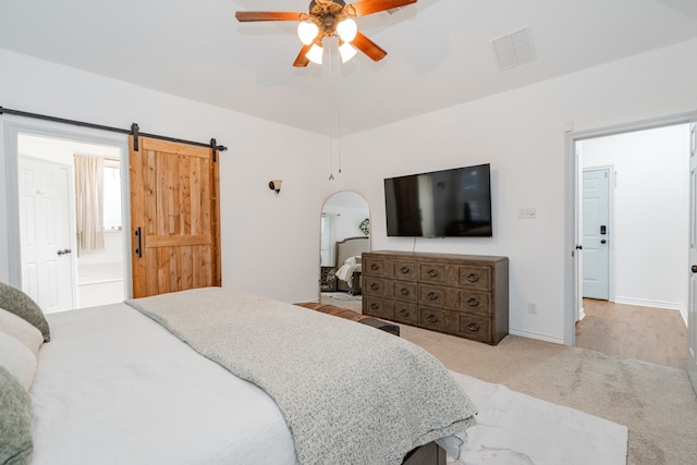 543 Islet Dr, Runaway Bay, TX 76426 - bedroom with carpet flooring, a ceiling fan, ensuite bath, and a barn door