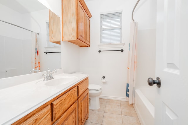 full bath featuring tile patterned flooring, vanity, toilet, shower / bath combo with shower curtain, and baseboards