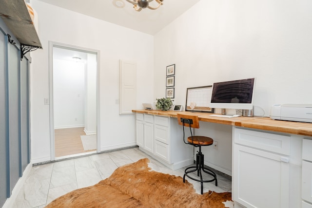 office featuring baseboards and built in study area