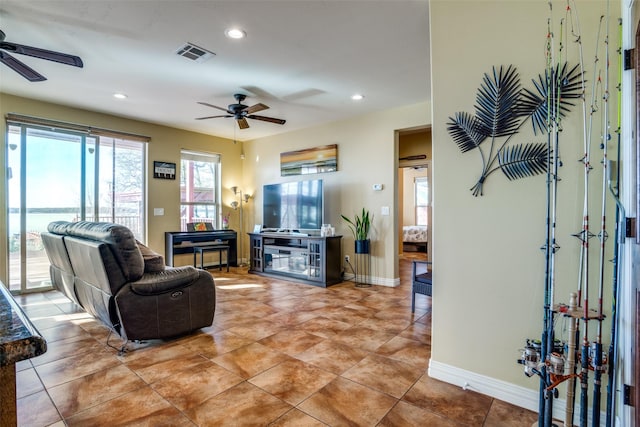living area with baseboards, a ceiling fan, recessed lighting, and visible vents