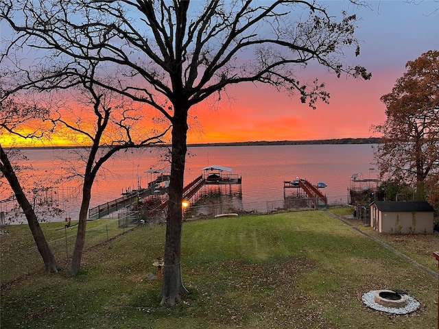 water view featuring boat lift and a dock