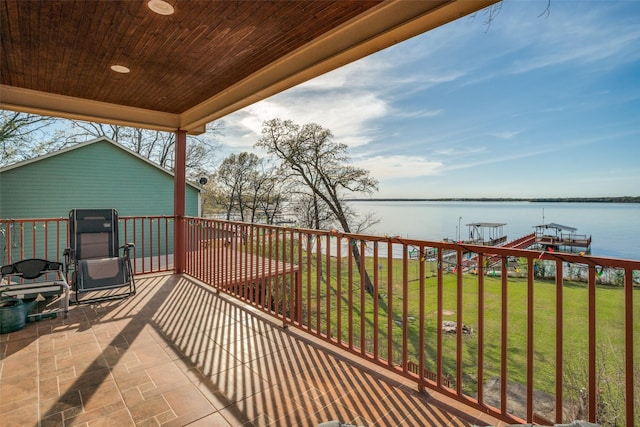 wooden deck with a water view and outdoor lounge area