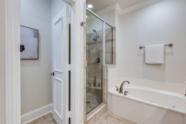 bathroom with crown molding, tile patterned floors, baseboards, a shower stall, and a garden tub