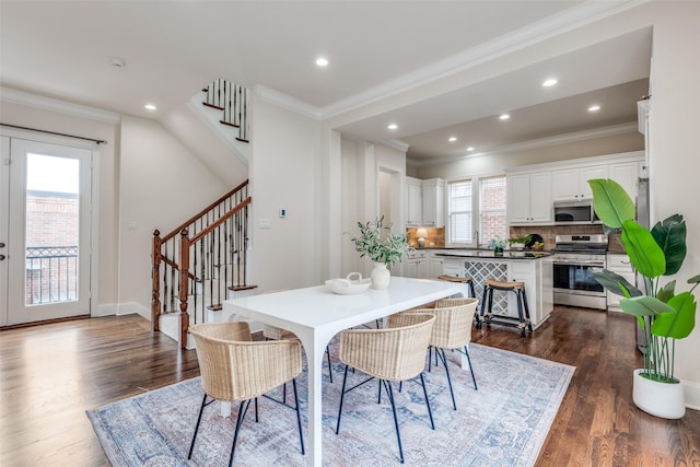 dining room featuring dark wood finished floors, recessed lighting, ornamental molding, and stairs