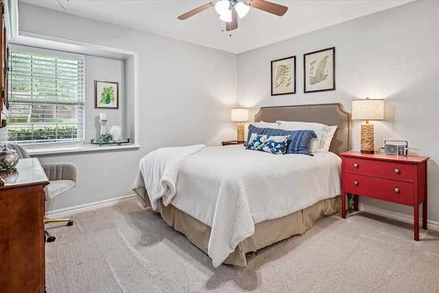 carpeted bedroom featuring baseboards and ceiling fan
