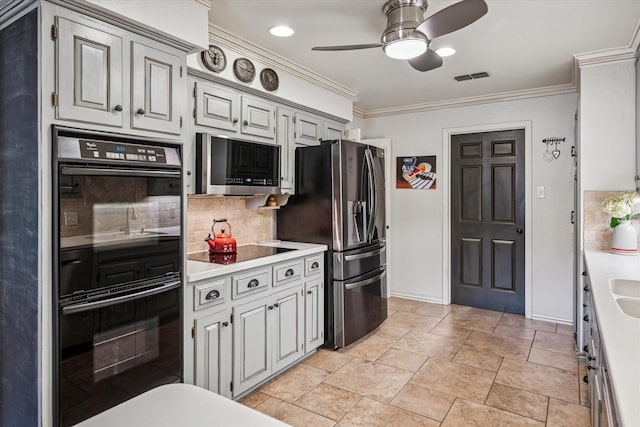 kitchen featuring ornamental molding, ceiling fan, light countertops, backsplash, and black appliances