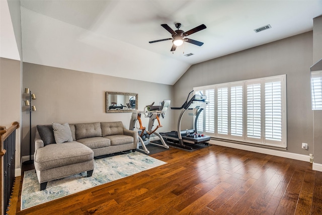 exercise room featuring ceiling fan, visible vents, baseboards, lofted ceiling, and hardwood / wood-style floors