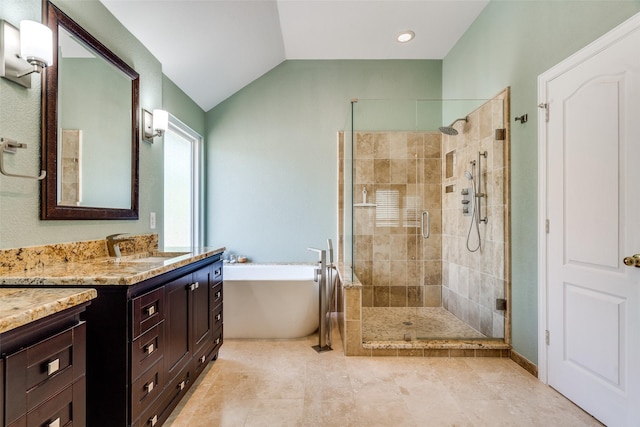 full bathroom with a sink, two vanities, and a soaking tub