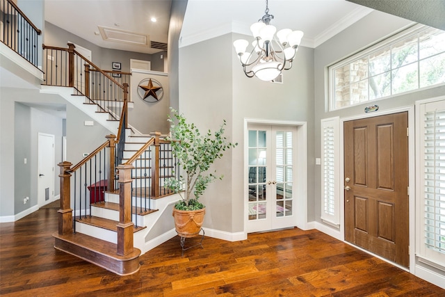 foyer featuring a high ceiling, french doors, hardwood / wood-style flooring, and a wealth of natural light