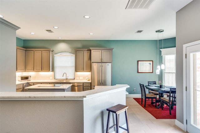 kitchen featuring backsplash, visible vents, light countertops, stainless steel appliances, and recessed lighting