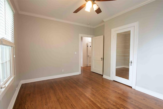 unfurnished bedroom with baseboards, crown molding, and wood finished floors