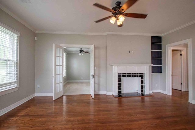 unfurnished living room with crown molding, a ceiling fan, and wood finished floors