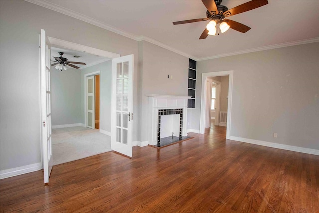 unfurnished living room featuring crown molding, a ceiling fan, baseboards, and built in features