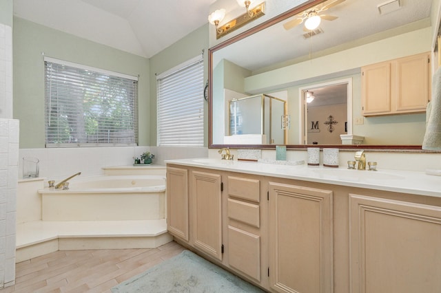 bathroom featuring double vanity, a sink, a ceiling fan, and a stall shower