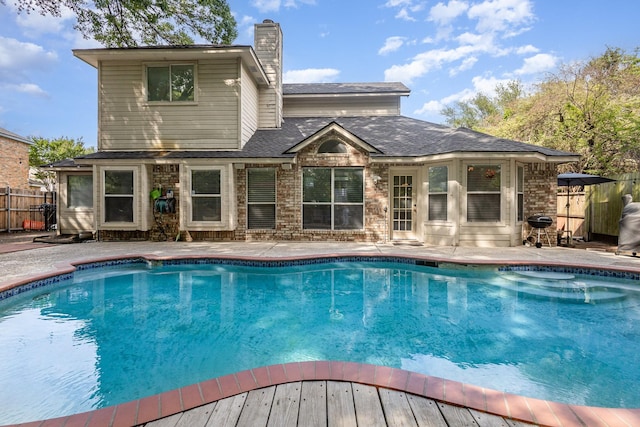 view of swimming pool with a fenced in pool, fence, and a patio