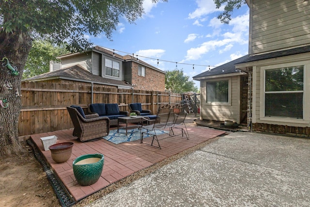 view of patio featuring an outdoor living space and a fenced backyard