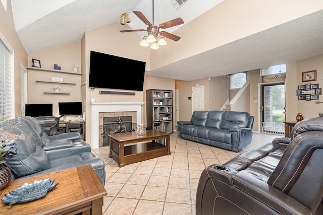 living room featuring visible vents, light tile patterned flooring, a fireplace, ceiling fan, and stairway