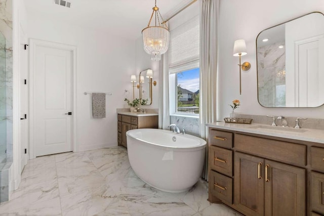 14336 Capridge Rd, Fort Worth, TX 76008 - full bath with a freestanding tub, marble finish flooring, a chandelier, two vanities, and a shower