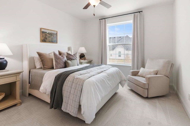 bedroom featuring ceiling fan and light carpet