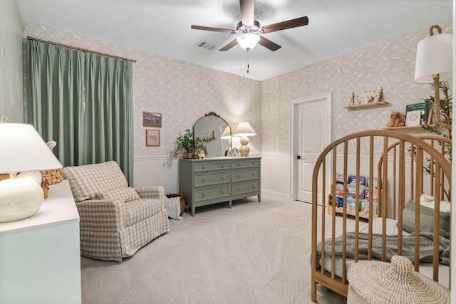 14336 Capridge Rd, Fort Worth, TX 76008 - bedroom featuring wainscoting, a crib, light colored carpet, wallpapered walls, and ceiling fan