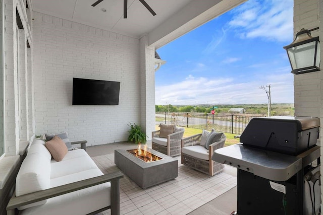 view of patio featuring fence, an outdoor living space with a fire pit, ceiling fan, and area for grilling