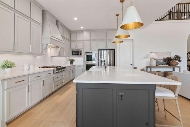14336 Capridge Rd, Fort Worth, TX 76008 - kitchen featuring stainless steel appliances, gray cabinets, custom range hood, a breakfast bar area, and recessed lighting