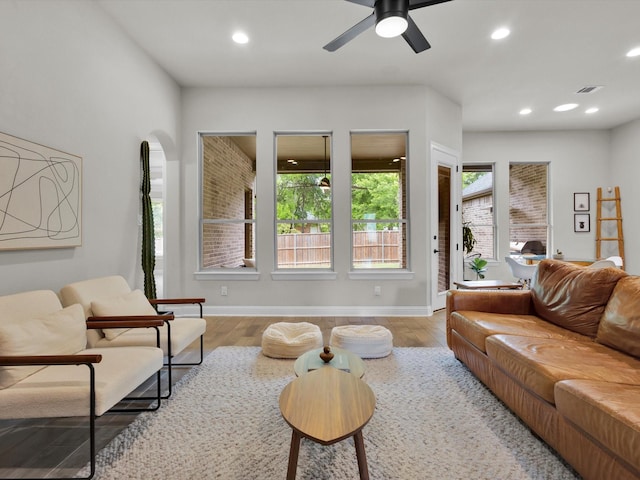 living area featuring baseboards, a ceiling fan, recessed lighting, and wood finished floors